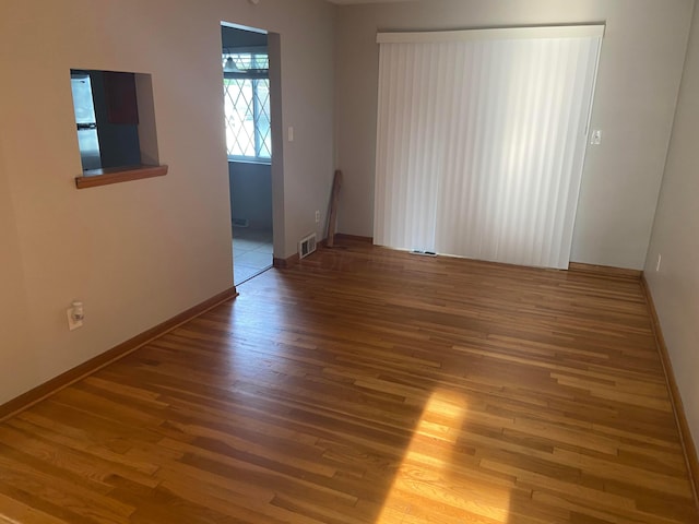 spare room with hardwood / wood-style floors