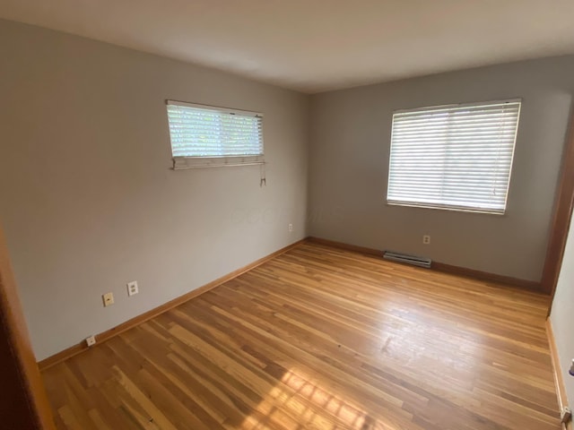 spare room with light hardwood / wood-style floors