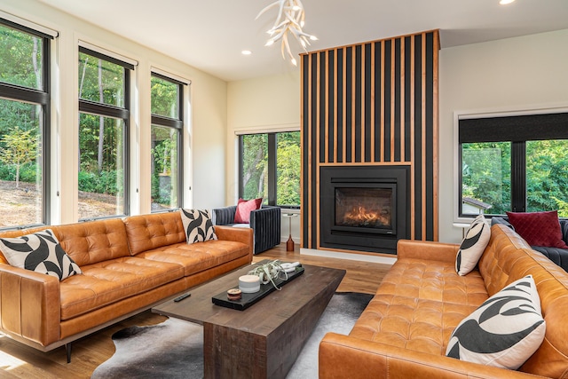 living room featuring a wealth of natural light and light hardwood / wood-style flooring