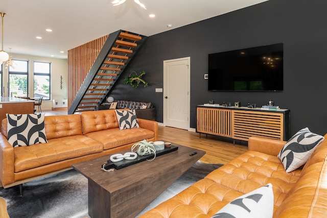 living room featuring a chandelier and light wood-type flooring