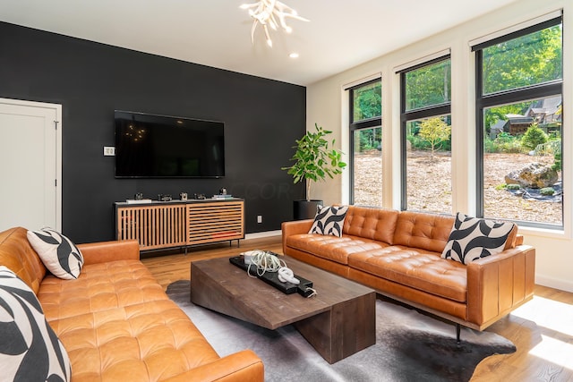 living room featuring wood-type flooring and a notable chandelier