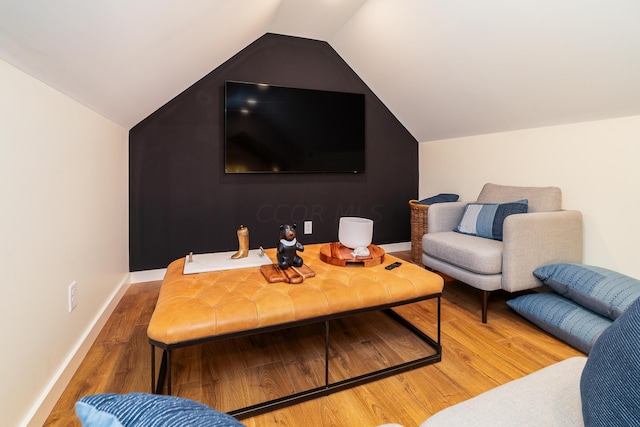 living room with hardwood / wood-style flooring and lofted ceiling