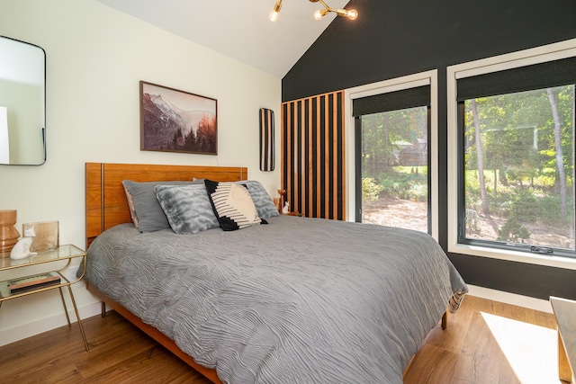 bedroom featuring hardwood / wood-style flooring and vaulted ceiling