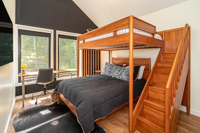 bedroom featuring wood-type flooring and lofted ceiling