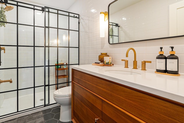 bathroom featuring tile patterned floors, toilet, and tile walls