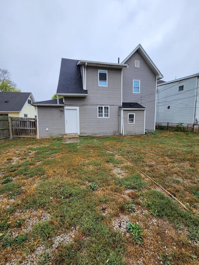 rear view of property with a yard