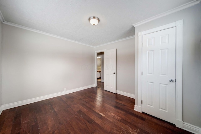 unfurnished bedroom featuring crown molding and dark wood-type flooring