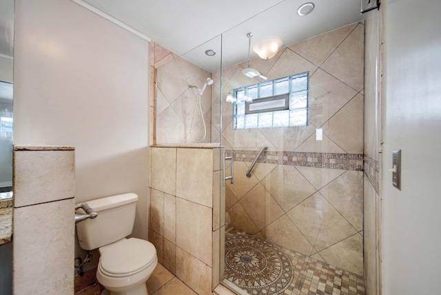 bathroom with a shower with door, tile patterned flooring, and toilet