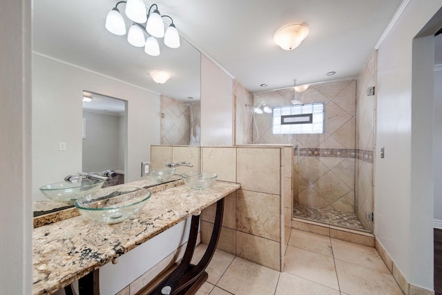 bathroom with tile patterned flooring, an enclosed shower, crown molding, and vanity