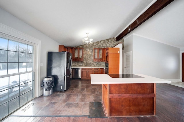 kitchen with a chandelier, a center island, lofted ceiling with beams, stainless steel appliances, and decorative backsplash