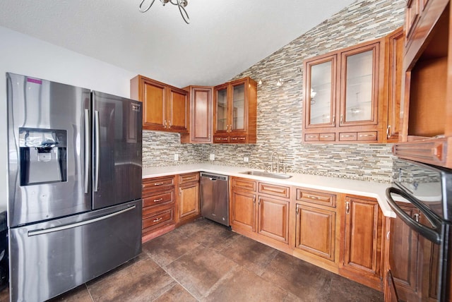 kitchen featuring tasteful backsplash, sink, lofted ceiling, and appliances with stainless steel finishes