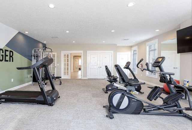 workout room with french doors, light colored carpet, and a textured ceiling