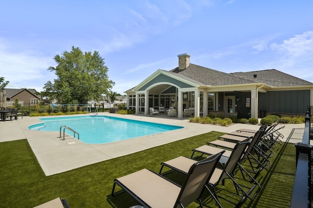 view of swimming pool with a patio and a lawn