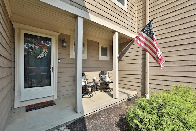 view of exterior entry with a porch