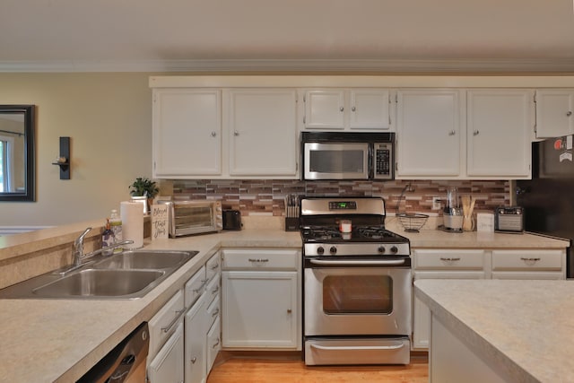 kitchen featuring sink, white cabinets, and appliances with stainless steel finishes