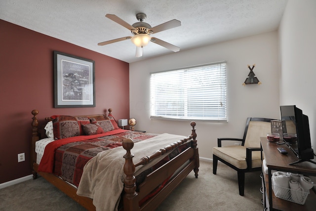 carpeted bedroom featuring a textured ceiling and ceiling fan