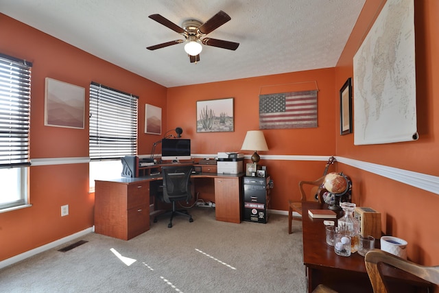 carpeted office with ceiling fan and a textured ceiling