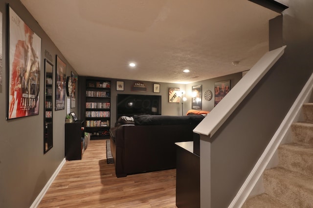 living room with hardwood / wood-style floors and a textured ceiling