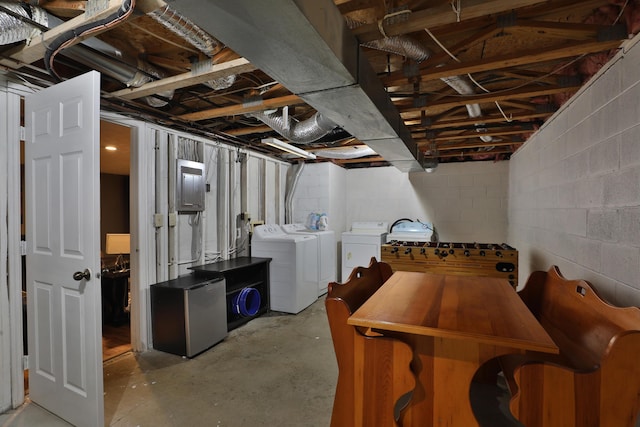 basement with washer and clothes dryer and stainless steel refrigerator