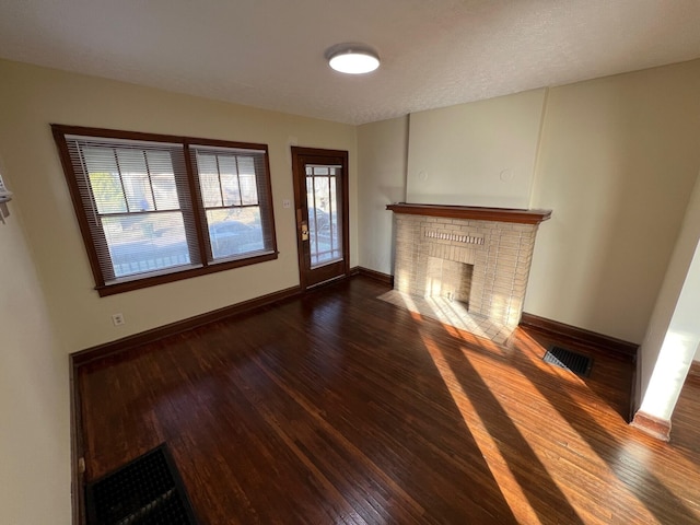 unfurnished living room featuring dark hardwood / wood-style floors and a fireplace