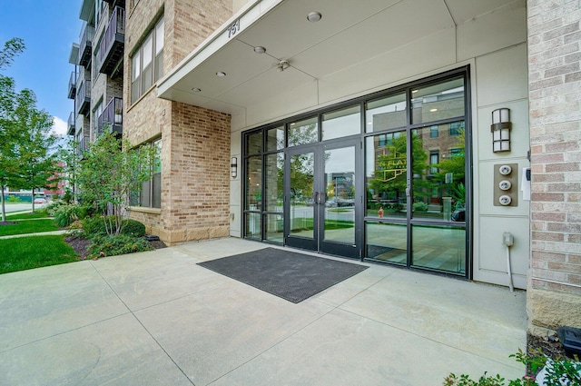 view of exterior entry with a patio and french doors