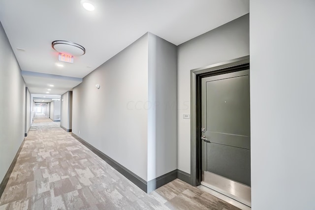 corridor with light wood-type flooring