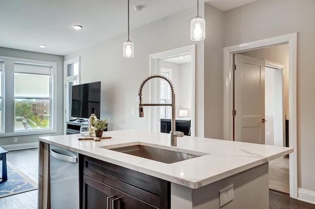 kitchen with decorative light fixtures, dark hardwood / wood-style flooring, dishwasher, and sink