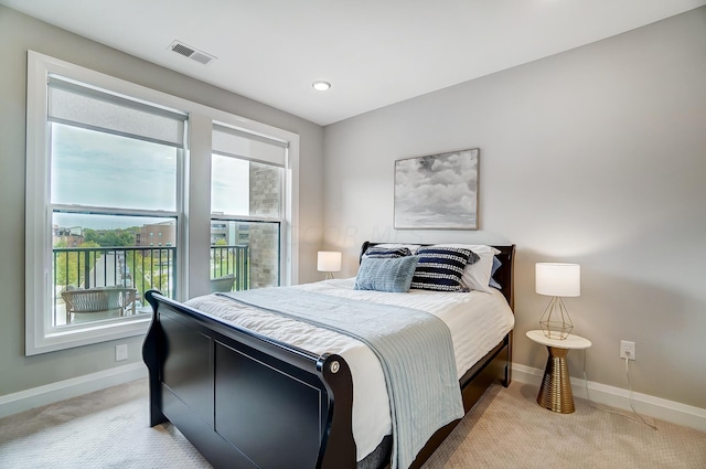 carpeted bedroom with multiple windows