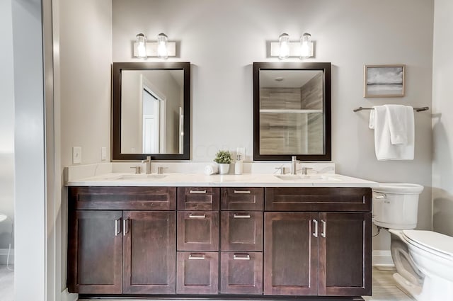 bathroom featuring vanity, hardwood / wood-style flooring, toilet, and an enclosed shower