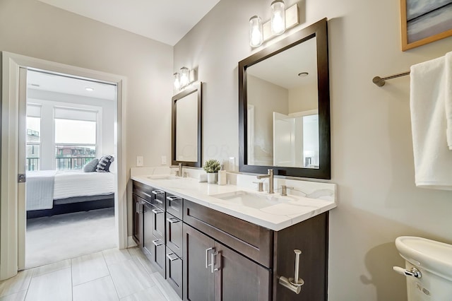 bathroom featuring tile patterned floors, vanity, and toilet