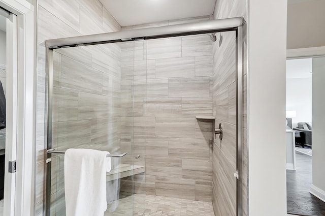 bathroom featuring hardwood / wood-style flooring and walk in shower