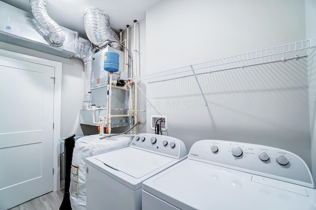 laundry area featuring light wood-type flooring and washing machine and clothes dryer