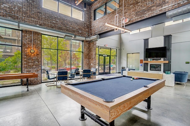 game room featuring concrete flooring, a high ceiling, french doors, and pool table