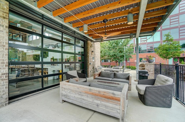 view of patio featuring an outdoor living space with a fire pit