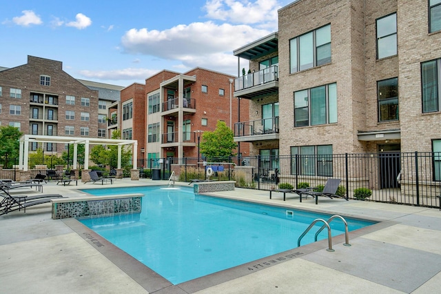 view of swimming pool with pool water feature