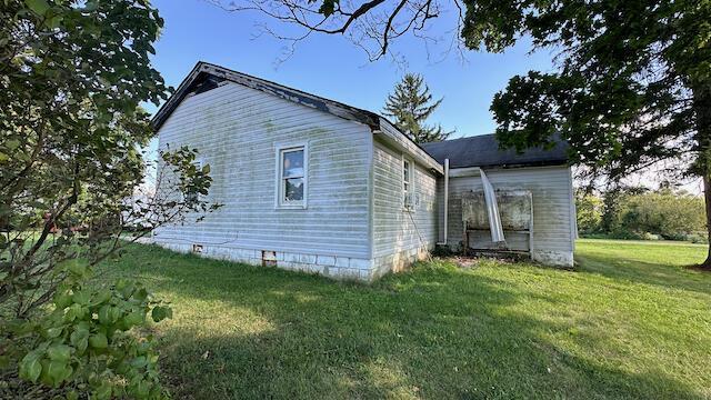 view of property exterior with a lawn