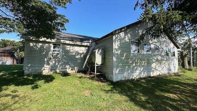 view of home's exterior with a lawn