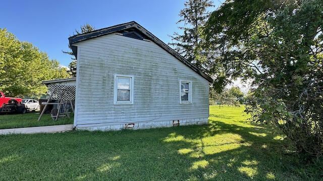 view of property exterior with a yard