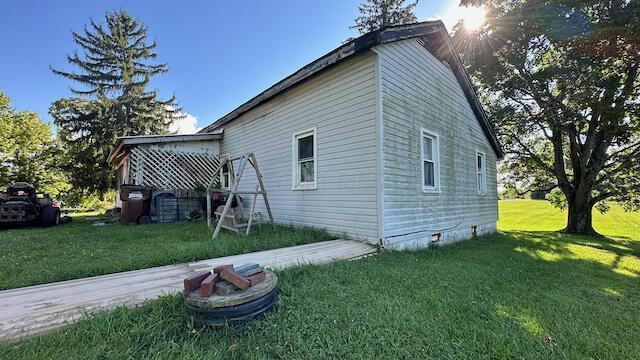 view of property exterior featuring a lawn