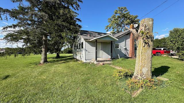 view of home's exterior with a lawn