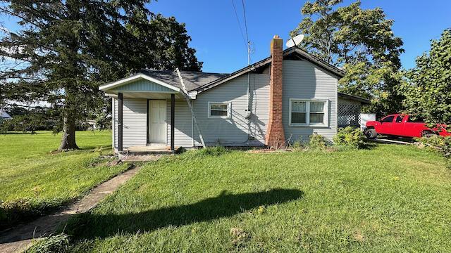 back of house with a yard