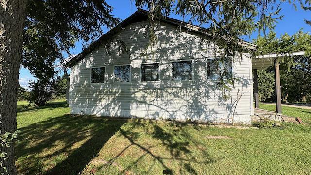 view of side of property featuring a yard