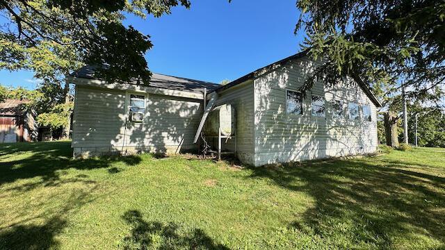 view of side of home featuring a yard