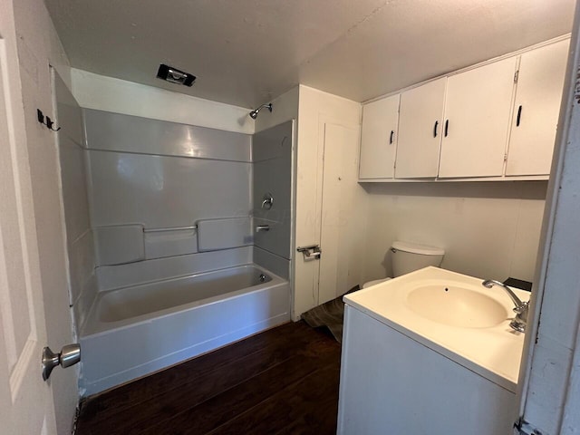 full bathroom with hardwood / wood-style flooring, vanity, toilet, and tub / shower combination