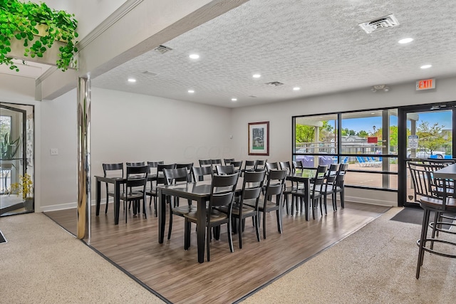 dining room featuring hardwood / wood-style floors and a textured ceiling