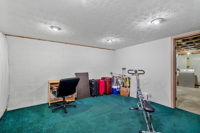 carpeted office with a textured ceiling and washer / clothes dryer