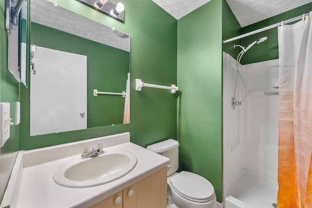 bathroom with a shower with curtain, vanity, a textured ceiling, and toilet