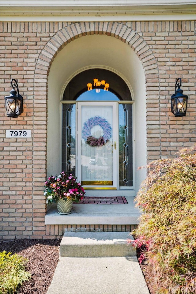 property entrance featuring brick siding