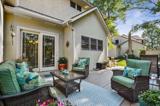 wooden terrace with an outdoor hangout area