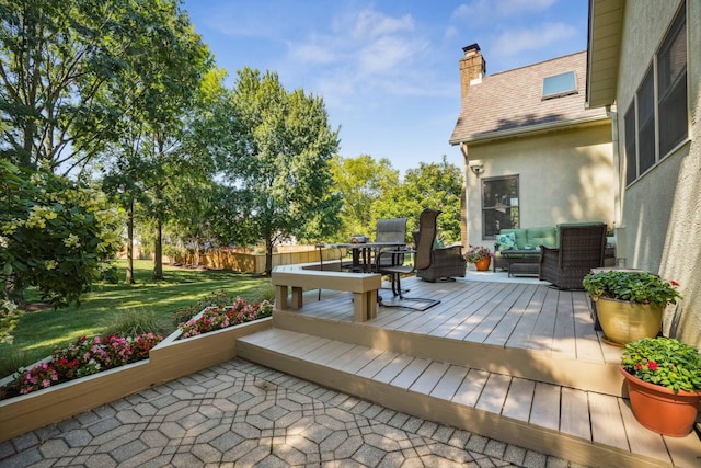 deck with a lawn and fence